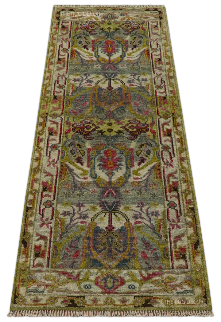 Full view of the floral runner rug with green, pink, and gold details and fringe