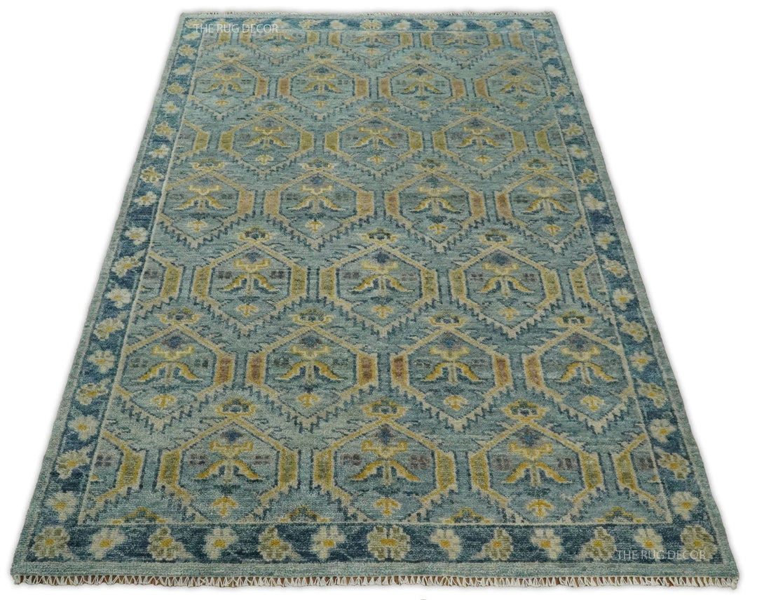 Full view of the traditional wool rug, with repeating geometric motifs and decorative border
