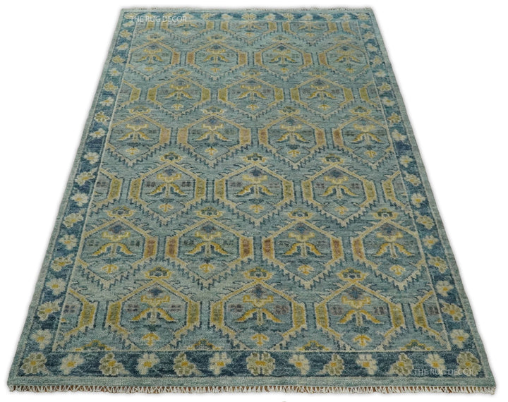 Full view of the traditional wool rug, with repeating geometric motifs and decorative border
