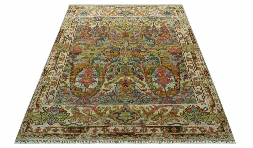 Hand-knotted wool rug with central medallions in green and gold with fringed ends