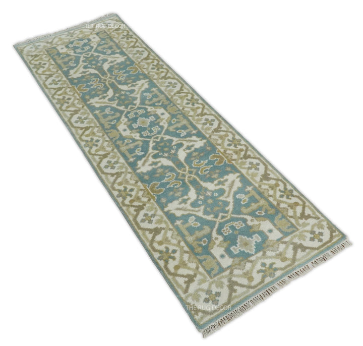 Angled view of the teal and ivory Oushak runner rug and its border