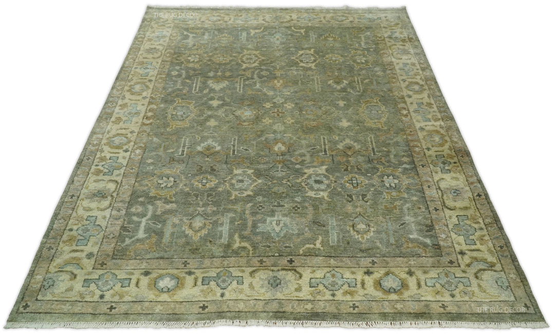 Rectangular vintage Turkish-style wool rug in gray-green with beige border and motifs
