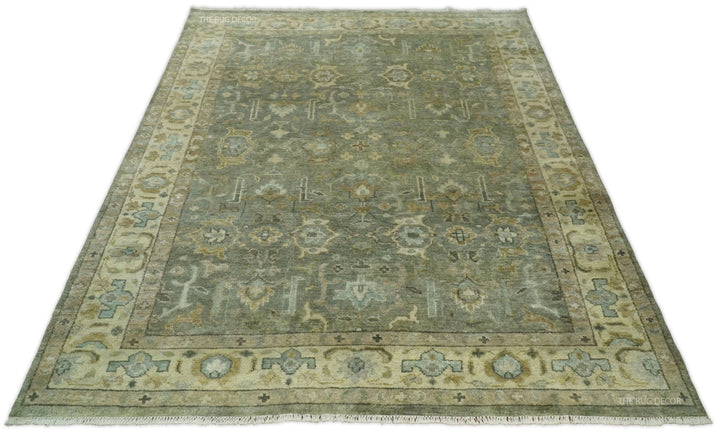 Rectangular vintage Turkish-style wool rug in gray-green with beige border and motifs