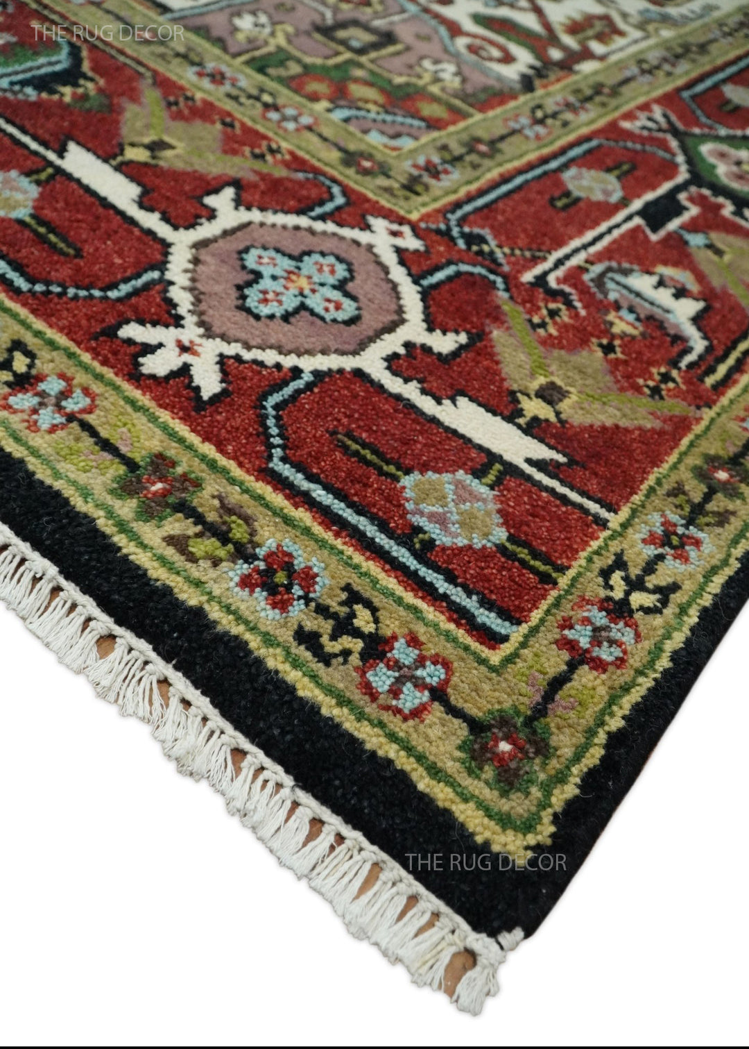 Hand-knotted wool rug corner detail with red, black, and green motifs and fringe