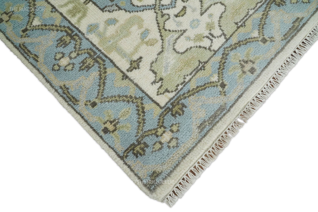 Runner rug corner showing its blue floral border and short ivory fringe