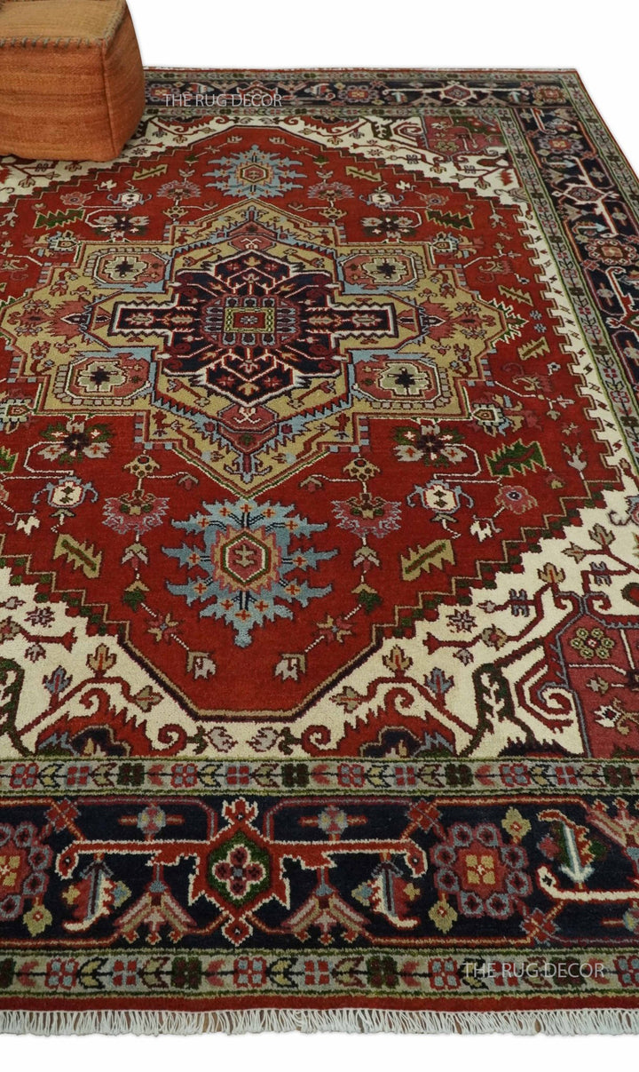 Red and blue Serapi rug displayed on the floor, showing its central medallion and fringed edge