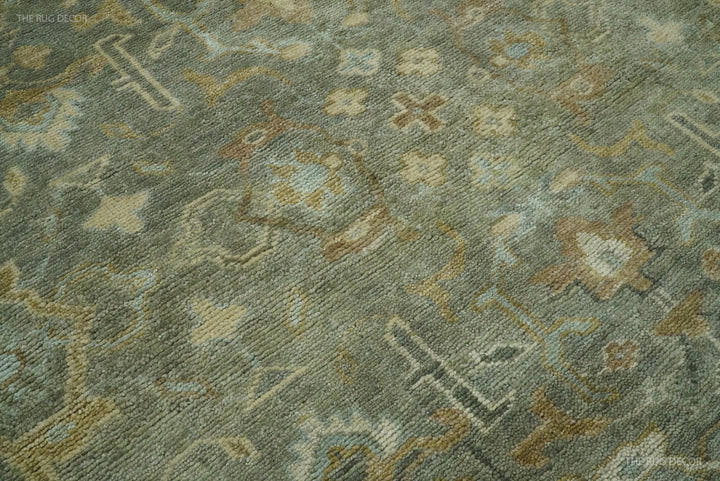 Close-up of vintage Turkish-style rug texture with gray-green ground and beige-orange motifs