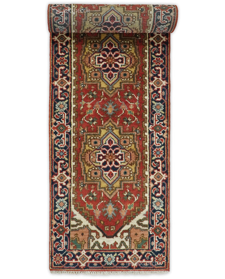 Serapi runner rug with a rolled end, rust field, blue borders, and repeating central medallions