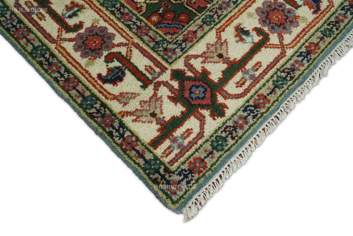 Rug corner detail showing its patterned border, woven pile, and fringe