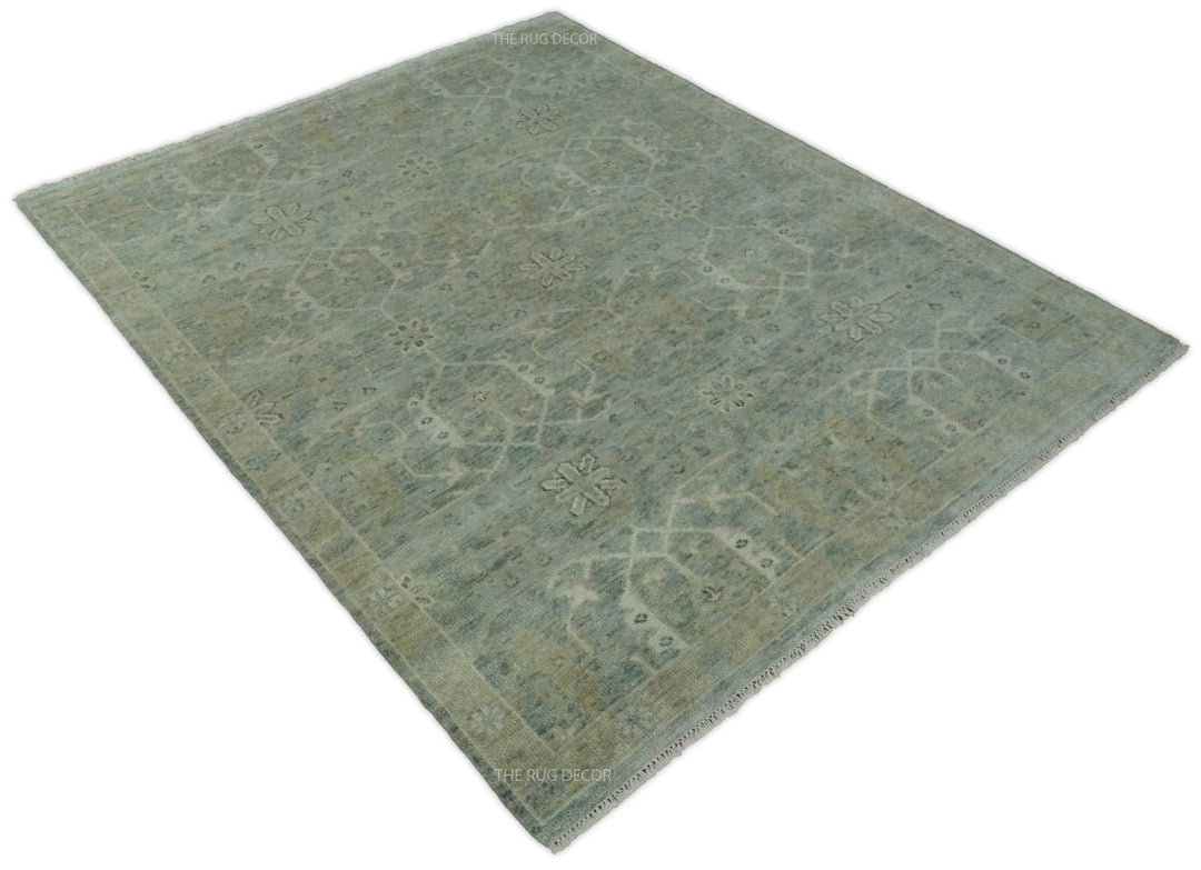 Angled view of a blue and ivory rug with a traditional floral pattern