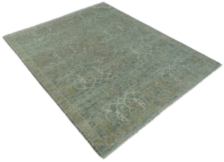 Angled view of a blue and ivory rug with a traditional floral pattern