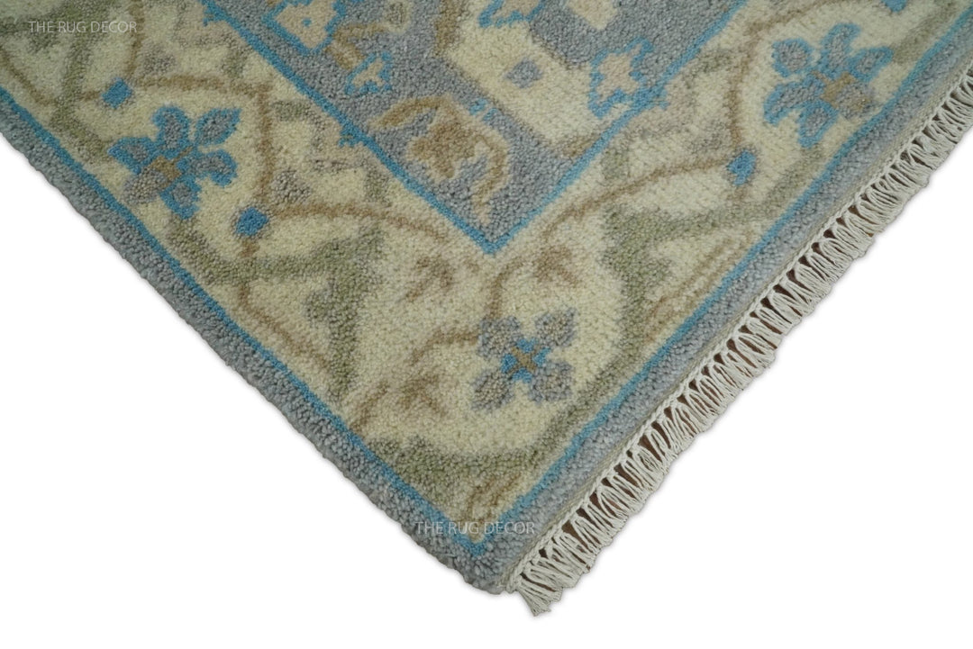 Runner rug corner showing beige fringe, blue edging, and floral border details
