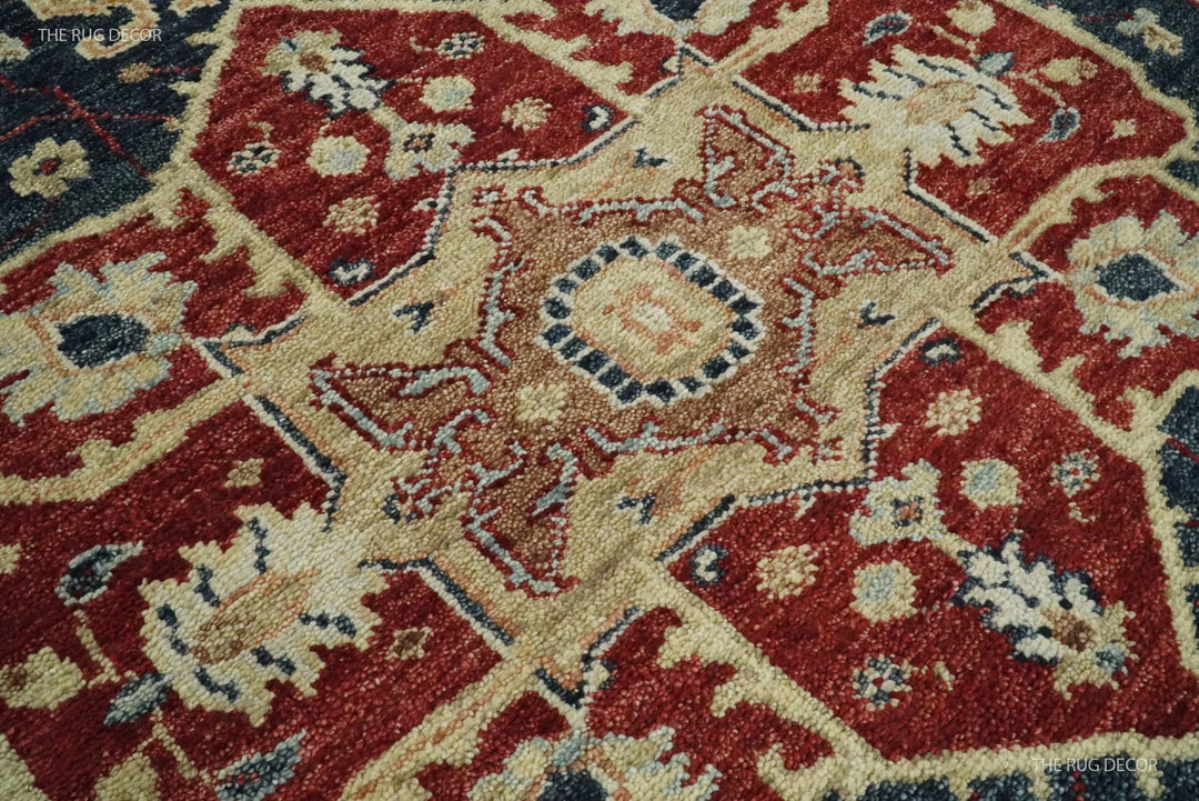 Close-up of the rug's red and cream central medallion on a dark blue field