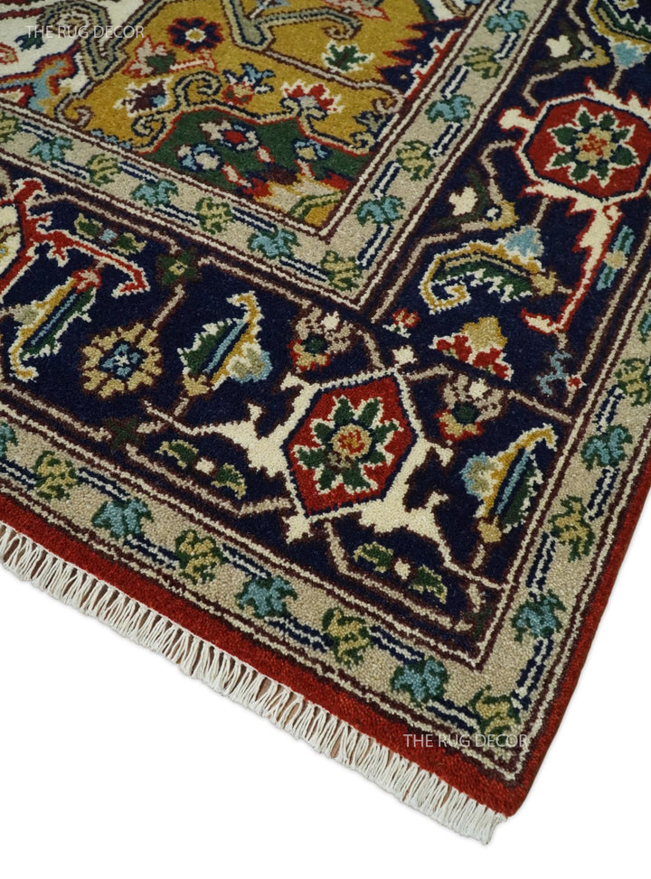 Rust and blue traditional Heriz Serapi area rug corner with decorative border and fringe