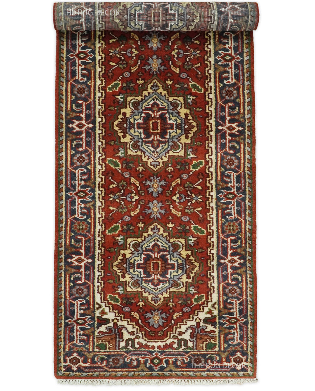 Sera Runner rug partially rolled to show its red field and ornate border