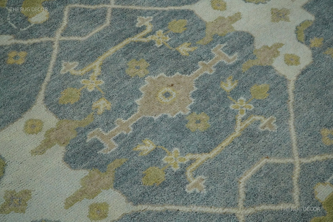 Oushak rug detail showing a gray ground, beige lattice, and floral motifs