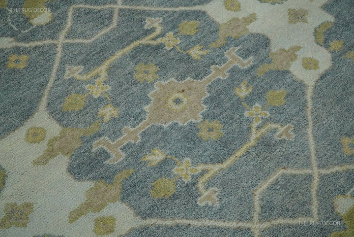 Oushak rug detail showing a gray ground, beige lattice, and floral motifs