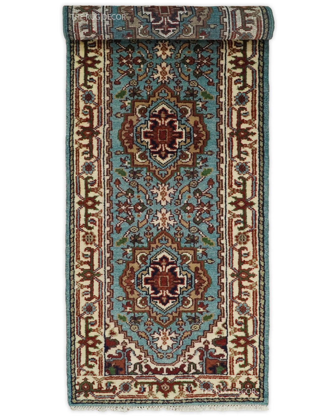 Hand-knotted runner rug partly rolled to show its blue floral pattern