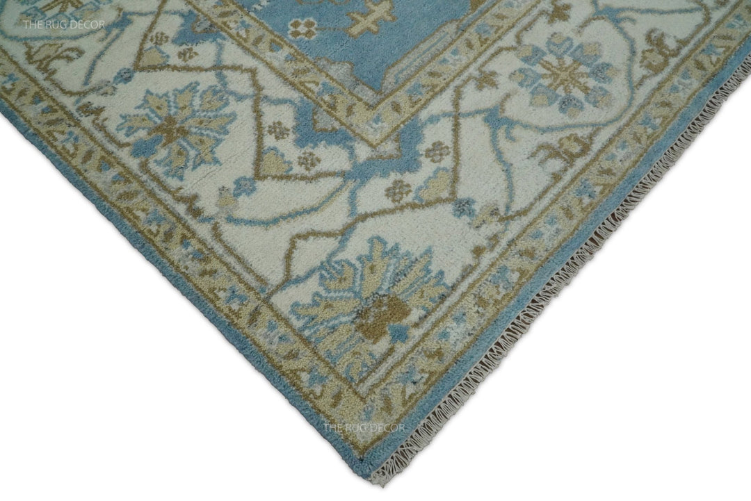 Ivory floral border, blue edging, and fringe at the corner of the wool rug