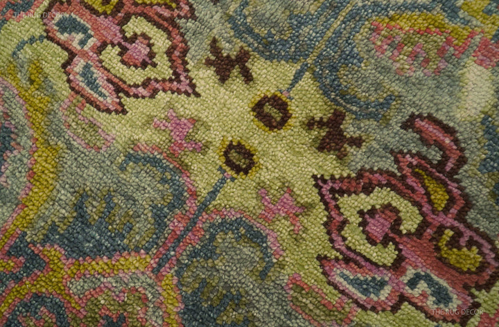Close-up of the runner rug's textured floral pile in green, pink, and gold