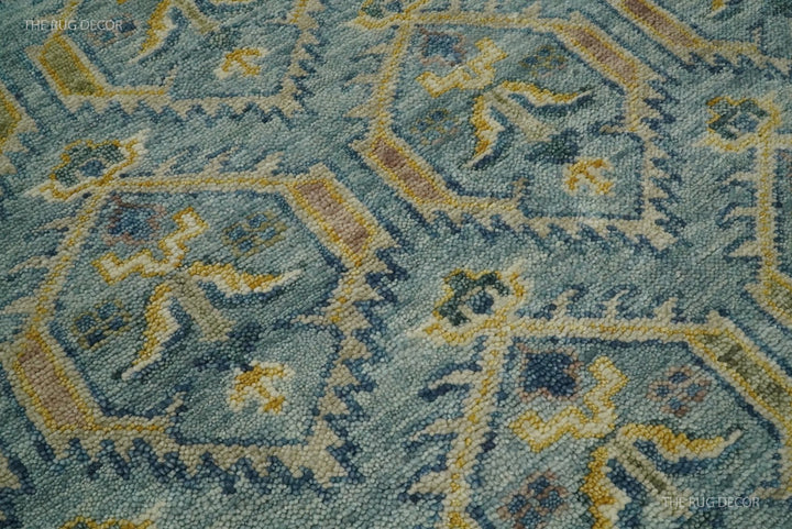 Close-up of hand-knotted wool texture and repeating geometric motifs in blue and mustard