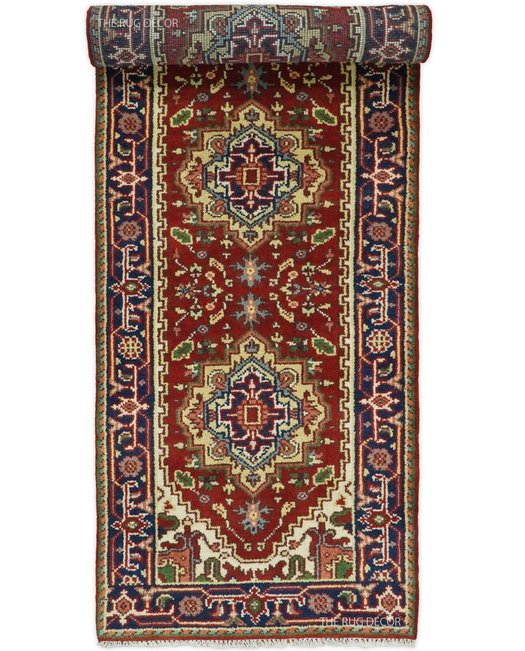 Red and blue patterned wool runner partially rolled to show its design