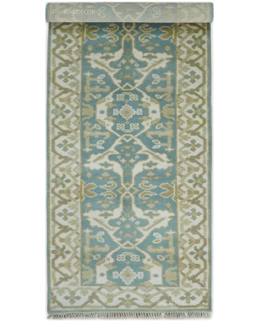 Oushak runner rug with one end folded back to show its pattern