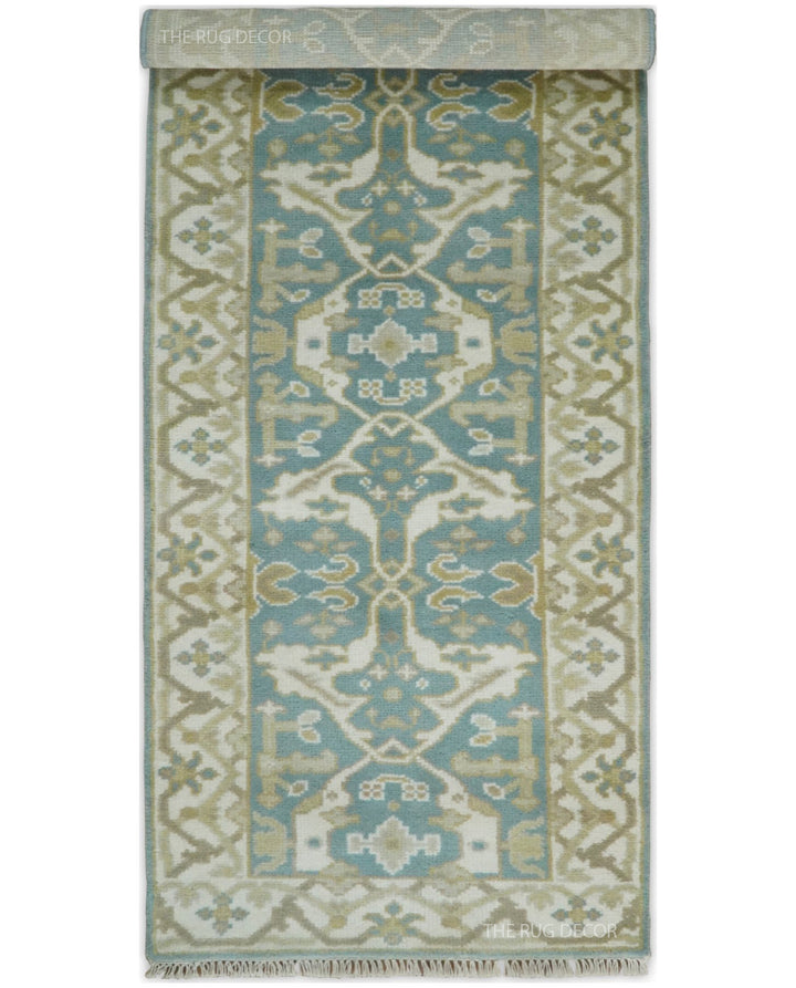 Oushak runner rug with one end folded back to show its pattern