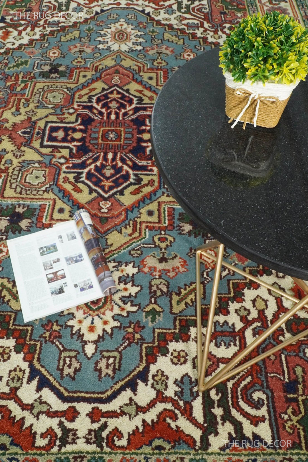 Blue and ivory medallion rug shown beneath a table, revealing its ornate pattern