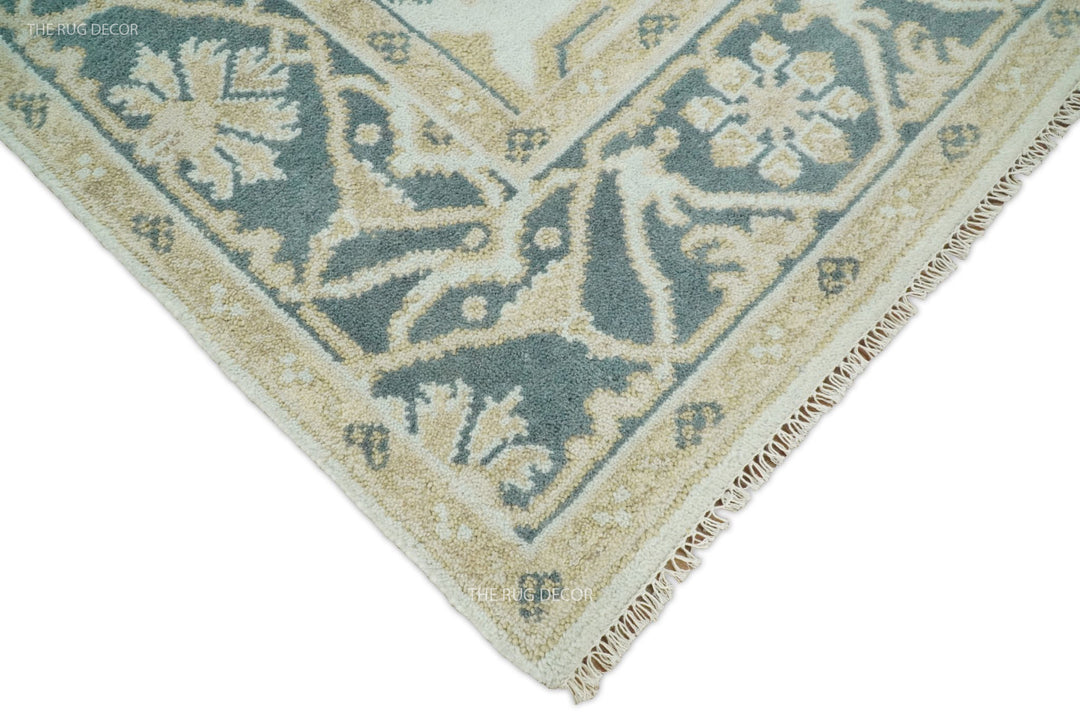 Teal and ivory Oushak wool rug corner with tassel fringe trim