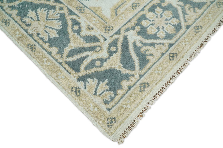 Teal and ivory Oushak wool rug corner with tassel fringe trim