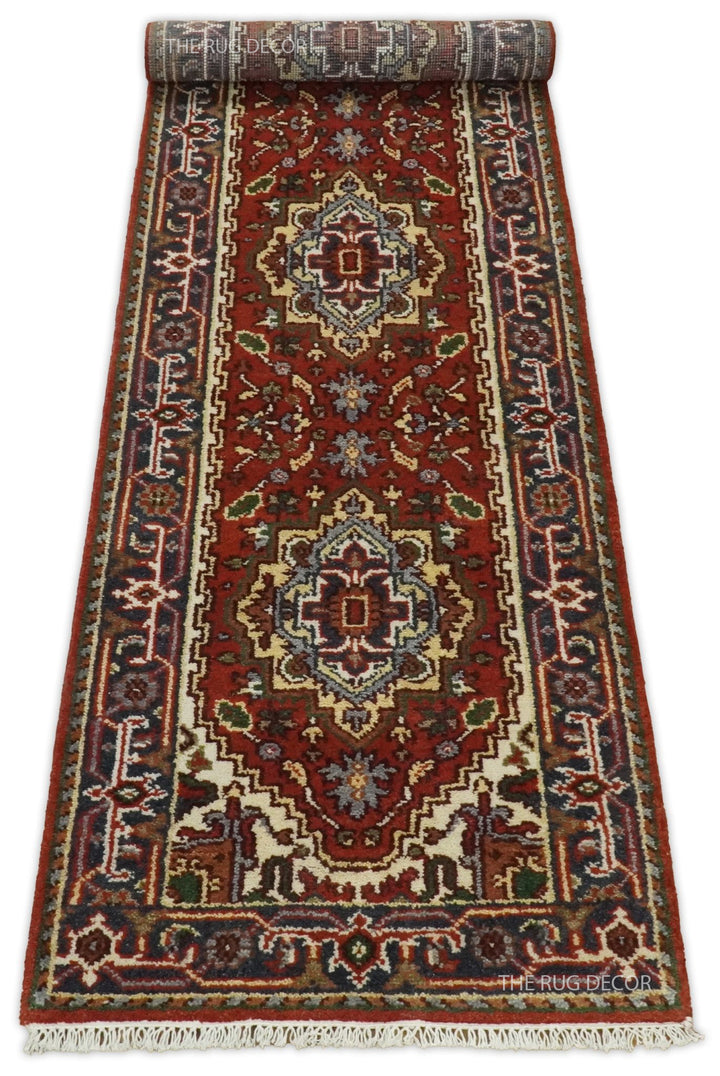 Sera Runner red and blue rug unrolled with cream fringe at the end