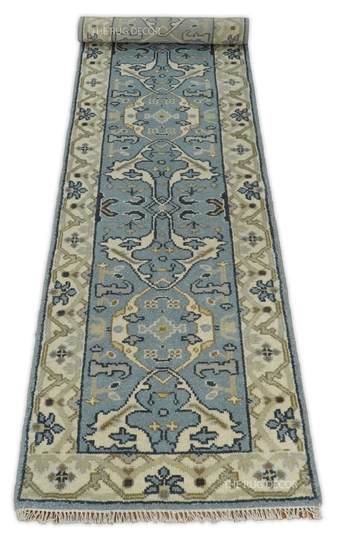 Long floral wool runner rug with beige borders and fringe at the near end