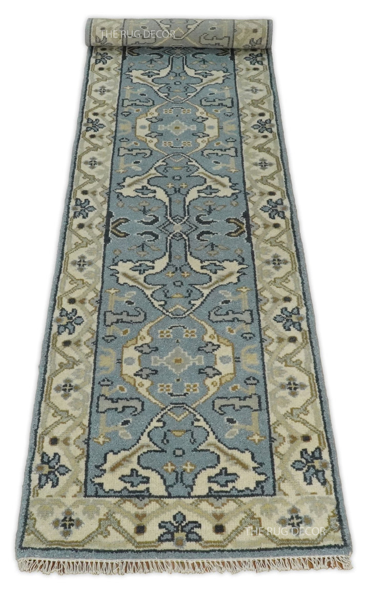 Long floral wool runner rug with beige borders and fringe at the near end