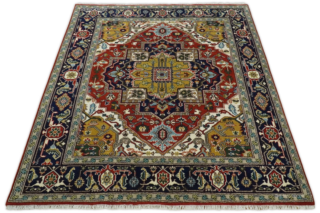 Rust and blue traditional Heriz Serapi area rug flat lay with central medallion border