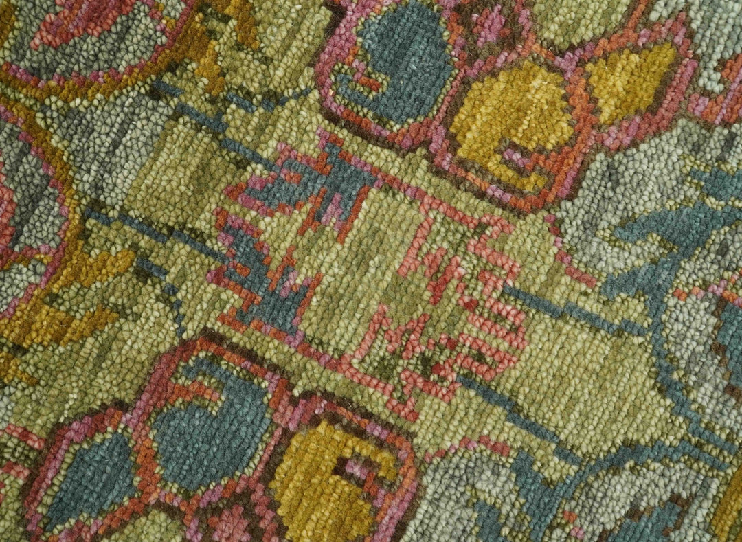 Hand-knotted wool rug yarn texture close-up in green, blue, and rust tones