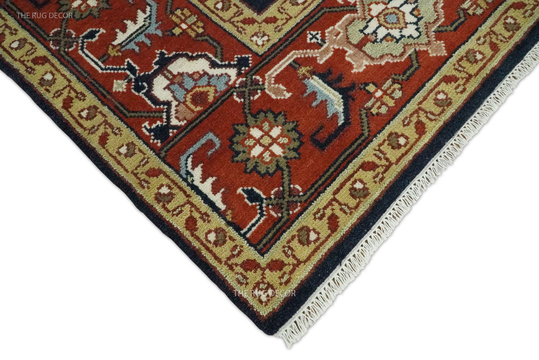 Rug corner showing its red border, woven motifs, and cream fringe