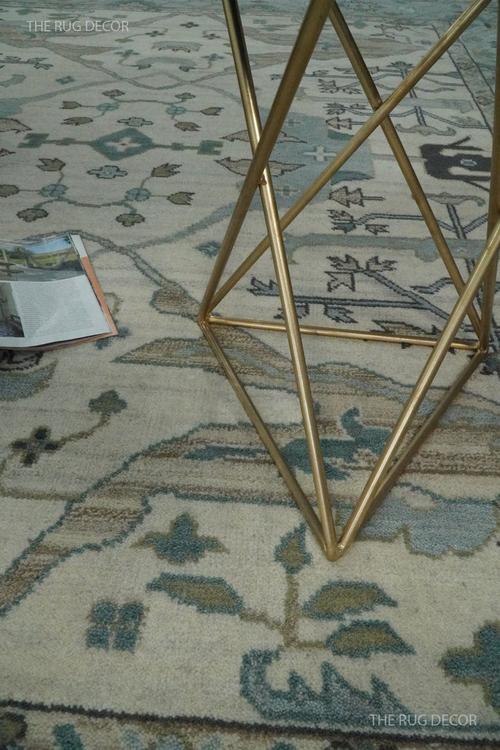 Close-up of the rug's wool pile and blue, ivory, and taupe floral pattern