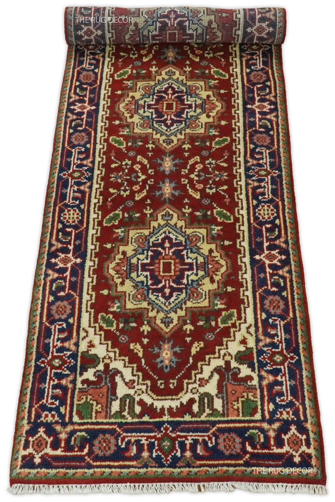 Wool runner unrolled from one end, displaying its red field and blue patterned borders