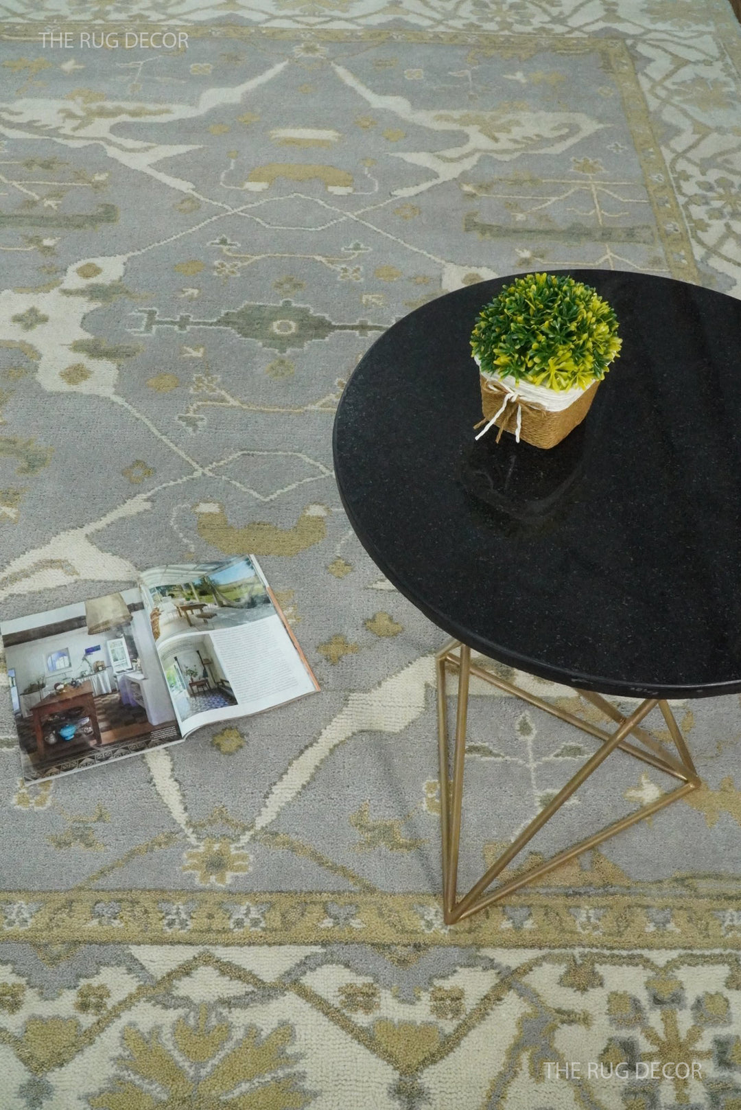 Gray and ivory Oushak rug with geometric floral motifs and decorative border