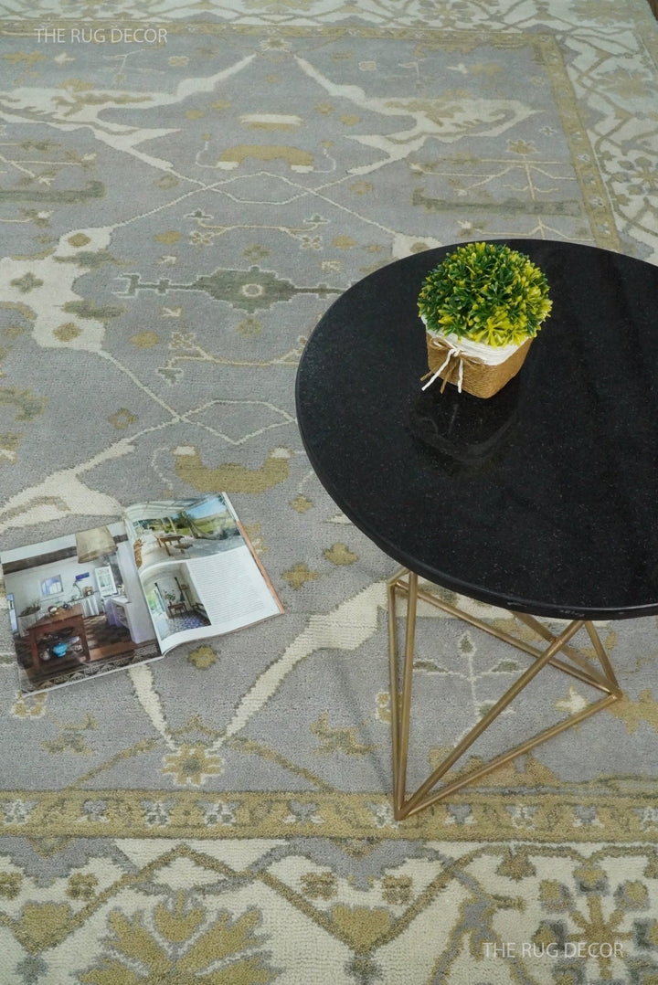 Gray and ivory Oushak rug with geometric floral motifs and decorative border