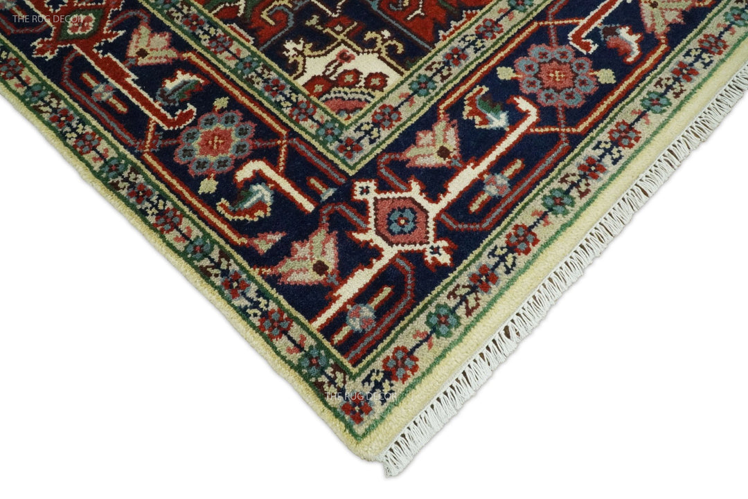 Hand-knotted wool rug border close-up with navy, teal, green, and maroon geometric motifs