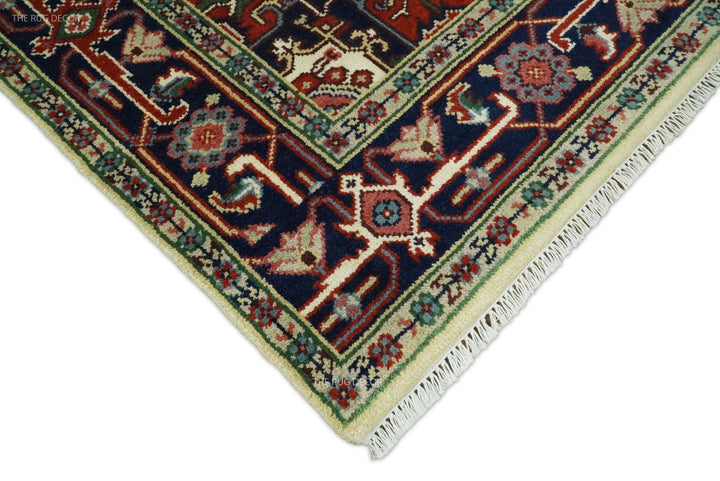 Hand-knotted wool rug border close-up with navy, teal, green, and maroon geometric motifs