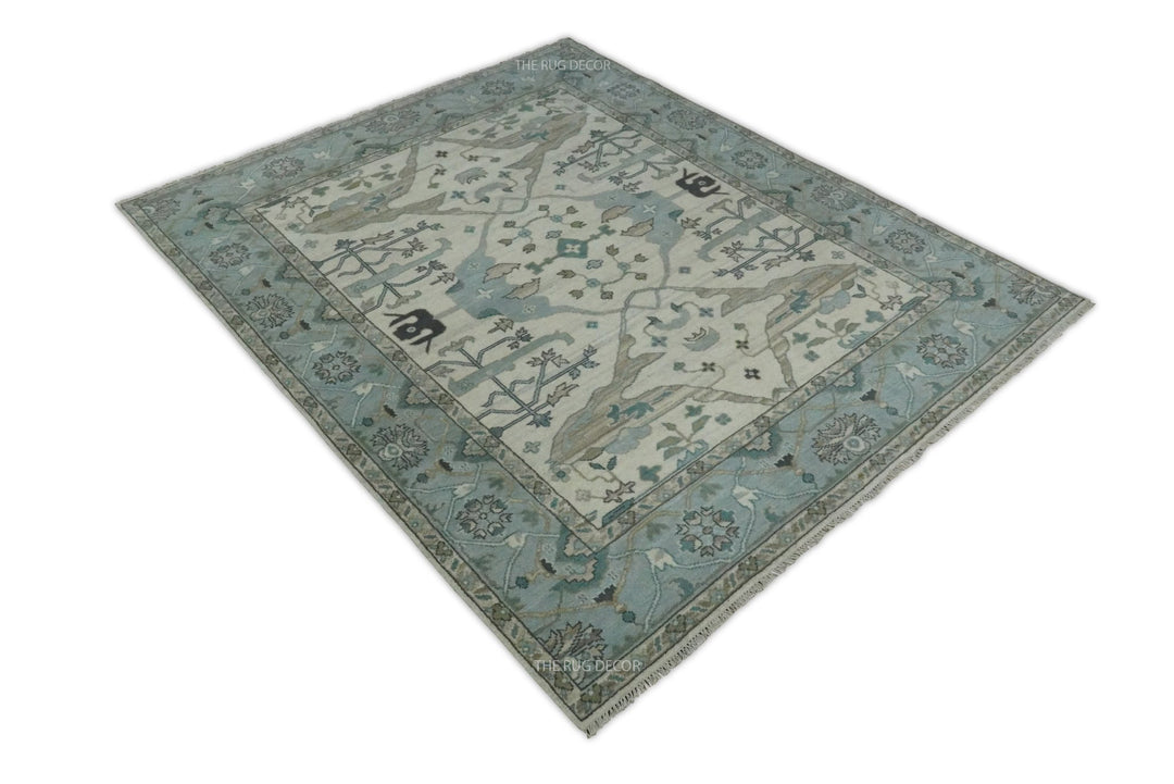Angled full view of the blue and ivory floral Oushak wool rug