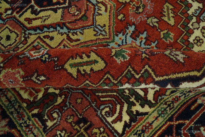 Close-up of rug field pattern with rust red shapes, dark blue outlines, and cream highlights