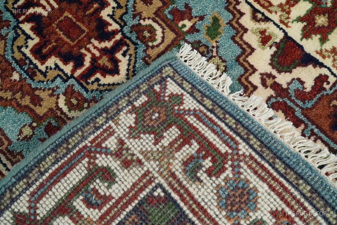 Rug underside and ivory fringe, showing the woven backing and blue border