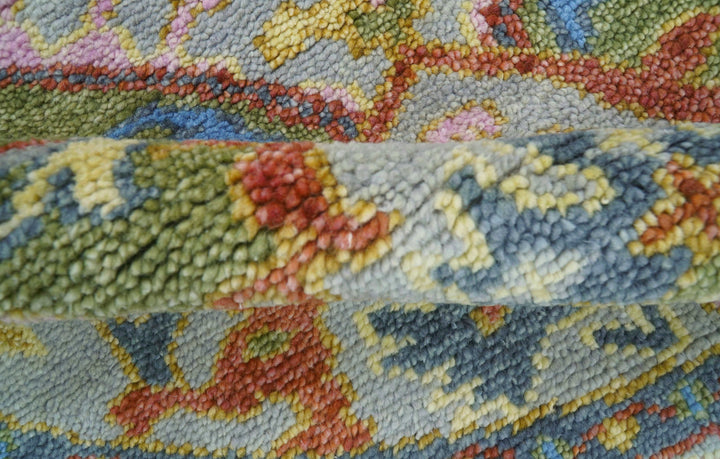 Close-up view of multicolor wool rug texture with red, yellow, green, and blue strands