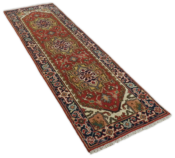 Angled view of the traditional runner rug with rust medallion field and ornate blue borders