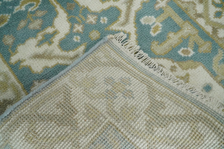 Folded rug corner reveals the woven backing and fringe