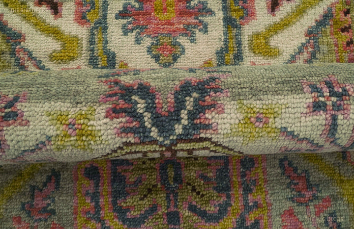 Folded runner rug showing its thick pile and detailed floral pattern